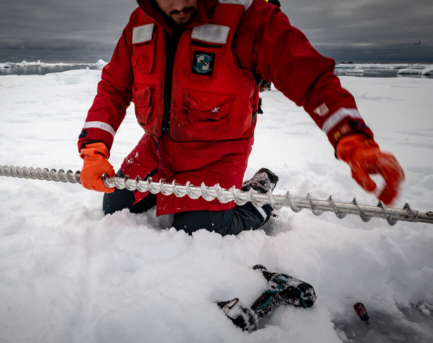 Researcher using Kovacs Ice Auger Drill